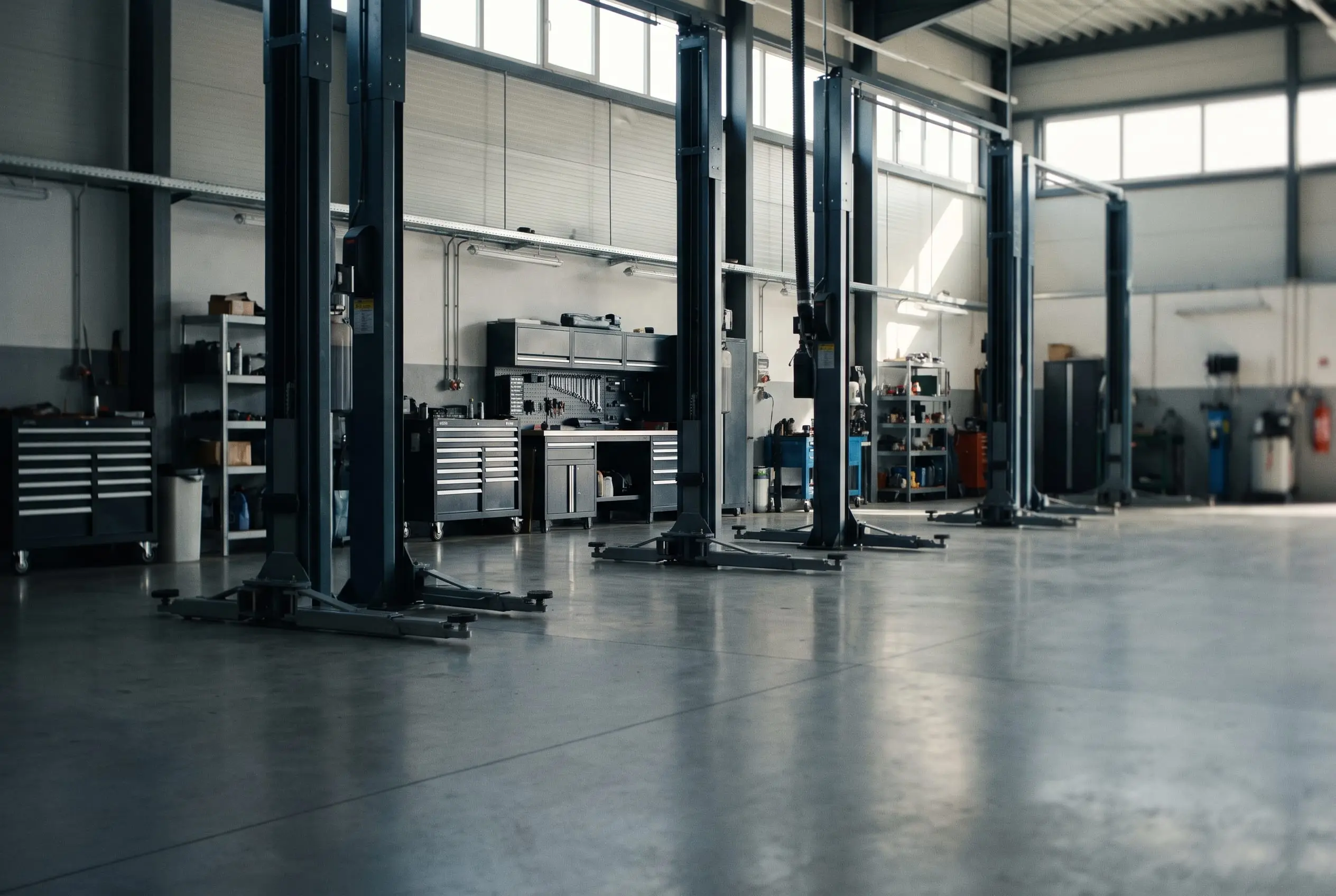 Bright, immaculate workshop with a 4x4 on the hoist