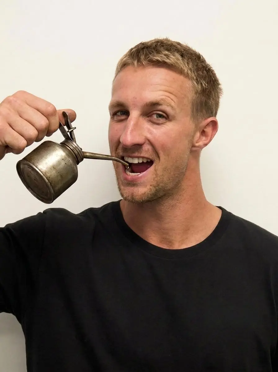 Ben Gaby pretending to drink from an oil can